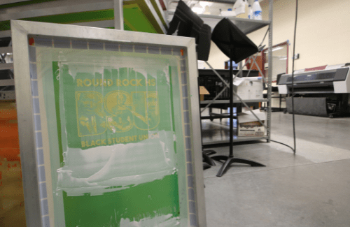 Screen print frame with classroom in background