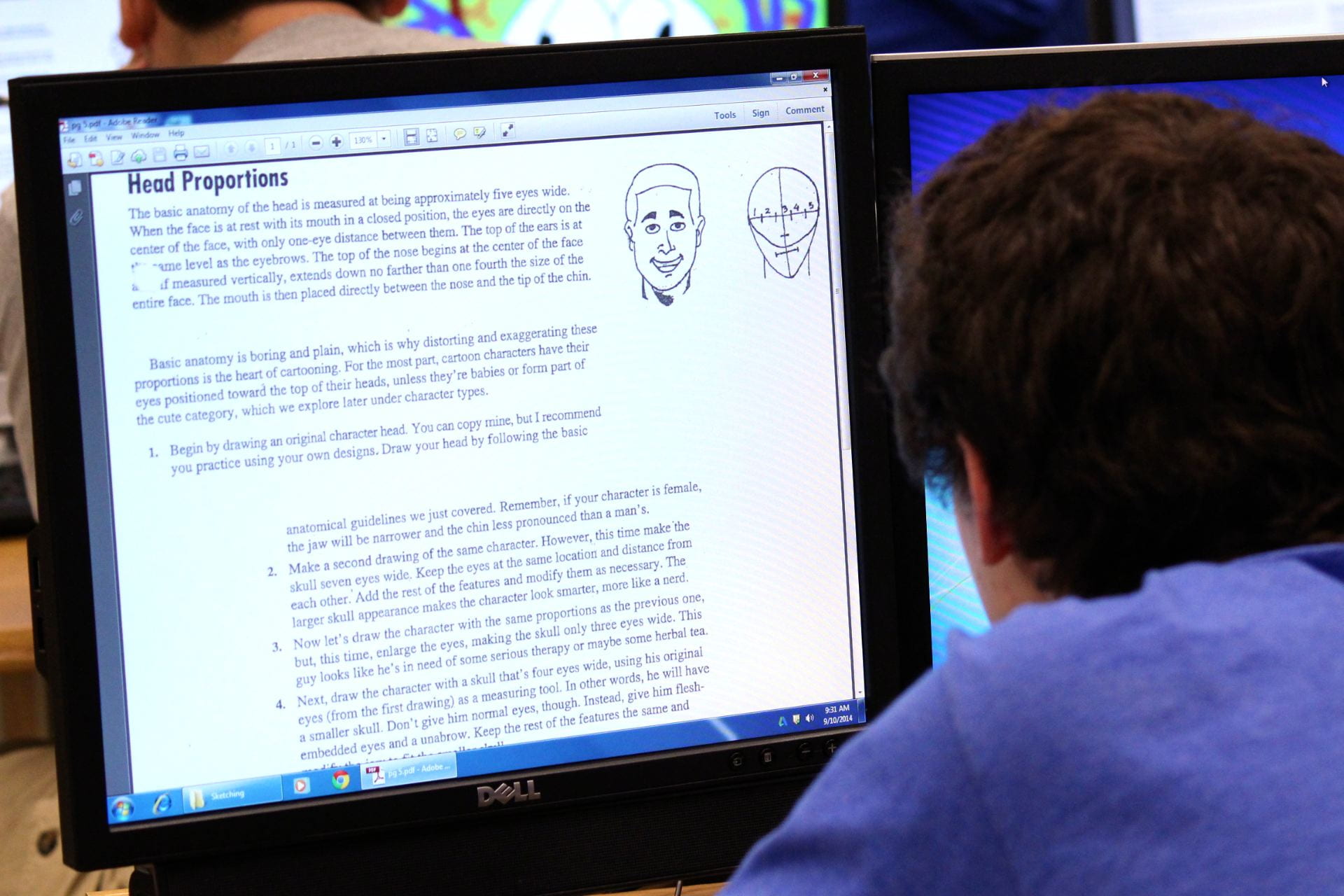 student looking at computer screen. Screen has instructions on how to animate human head